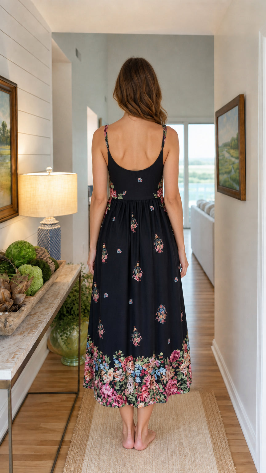 Back view of woman wearing black floral embroidered midi dress