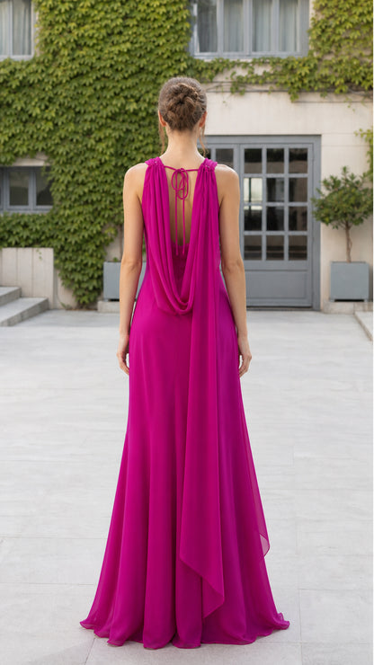 Back view of model showing cascading drape and open back details