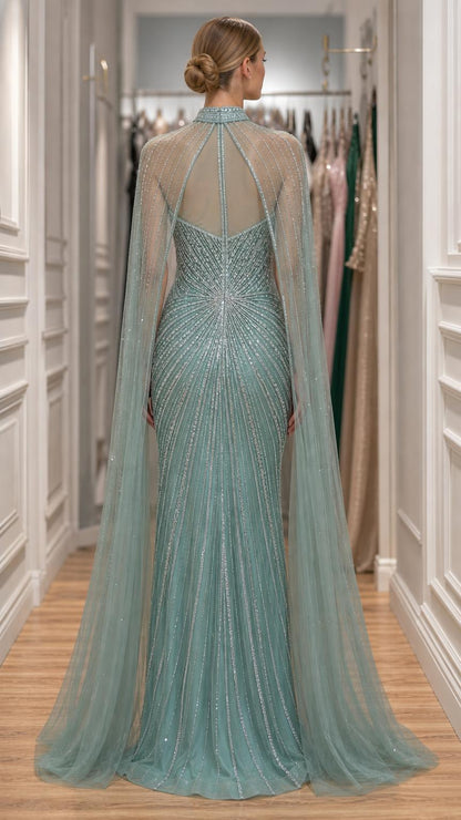 Back view showcasing the tulle cape and beaded detailing of the sage green gown