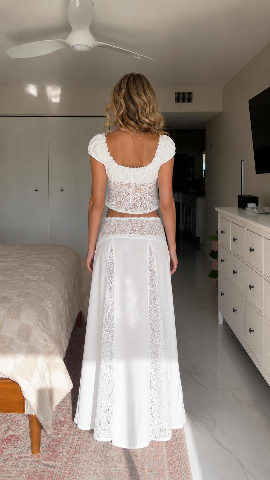 Back view of model showcasing white lace skirt and top