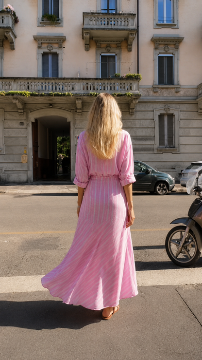 Back view of pink striped maxi shirt dress with long sleeves and flared hem