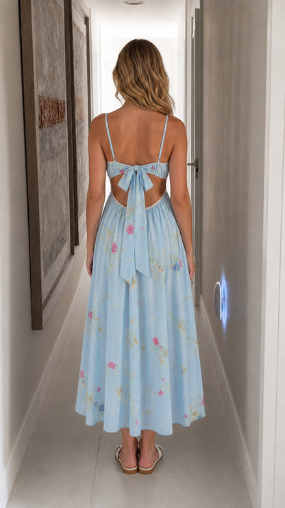 Back view showing bow tie detail on light blue floral midi dress