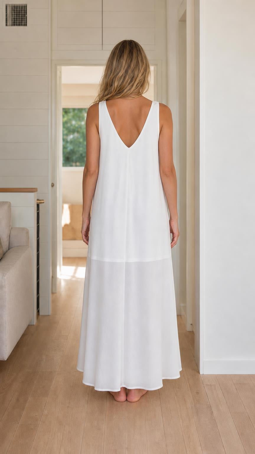 Back view of woman wearing white sleeveless maxi dress