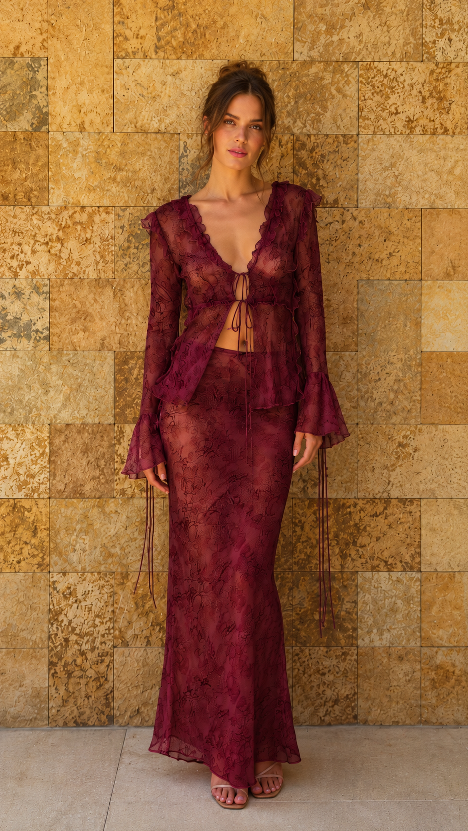 Model wearing burgundy sheer lace matching top and maxi skirt