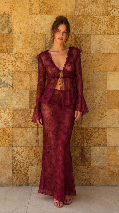 Model wearing burgundy sheer lace matching top and maxi skirt