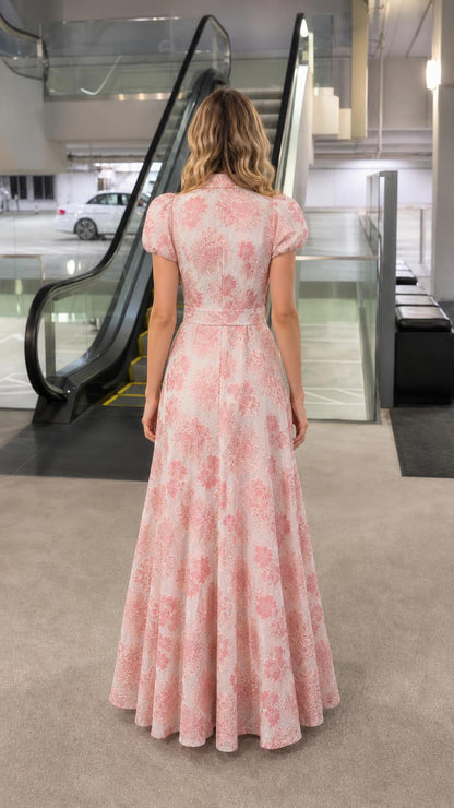 Back view of woman in pink floral maxi dress