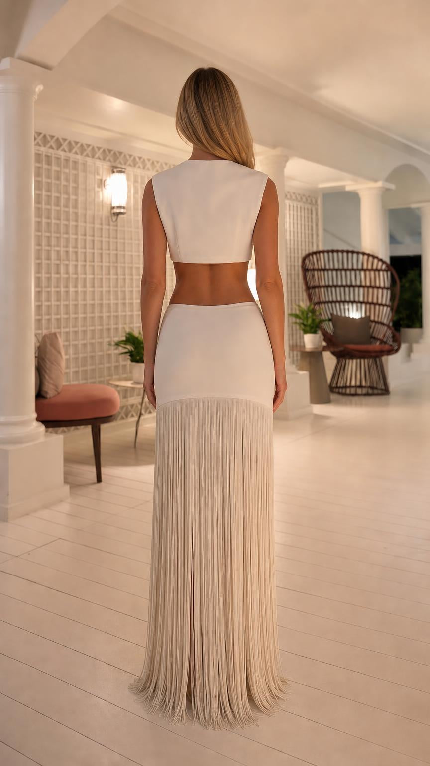 Back view of model showing back cutout detail on white top and skirt