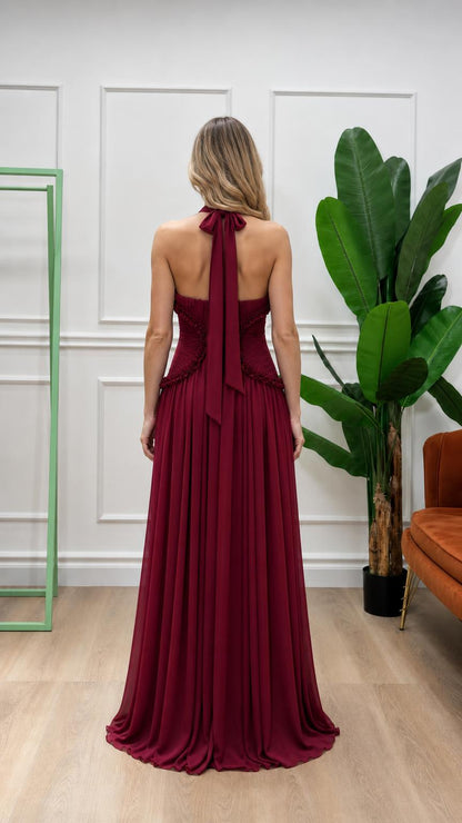 Back view of burgundy halter pleated maxi dress