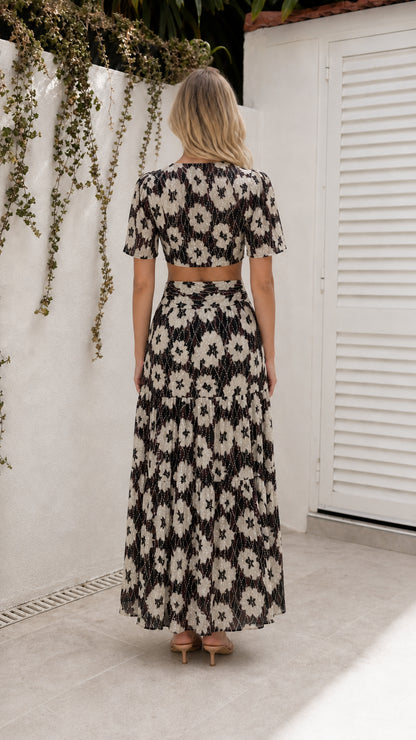 Back view of model wearing black floral cutout maxi dress