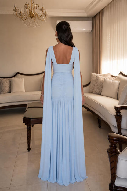 Back view showing flowing cape panels on Light Blue gown