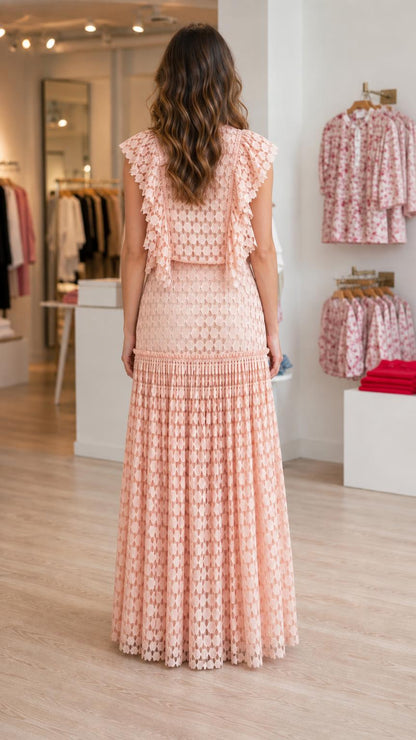 Model wearing pink ruffled maxi dress from back