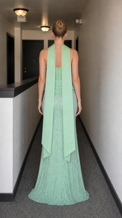 Back view of model showing draped scarf detail on sage gown