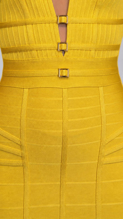 Close-up of bodice detailing, neckline, and gold buckles on yellow dress