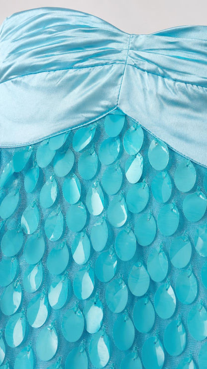 Close-up detail of satin bodice and textured turquoise appliqués