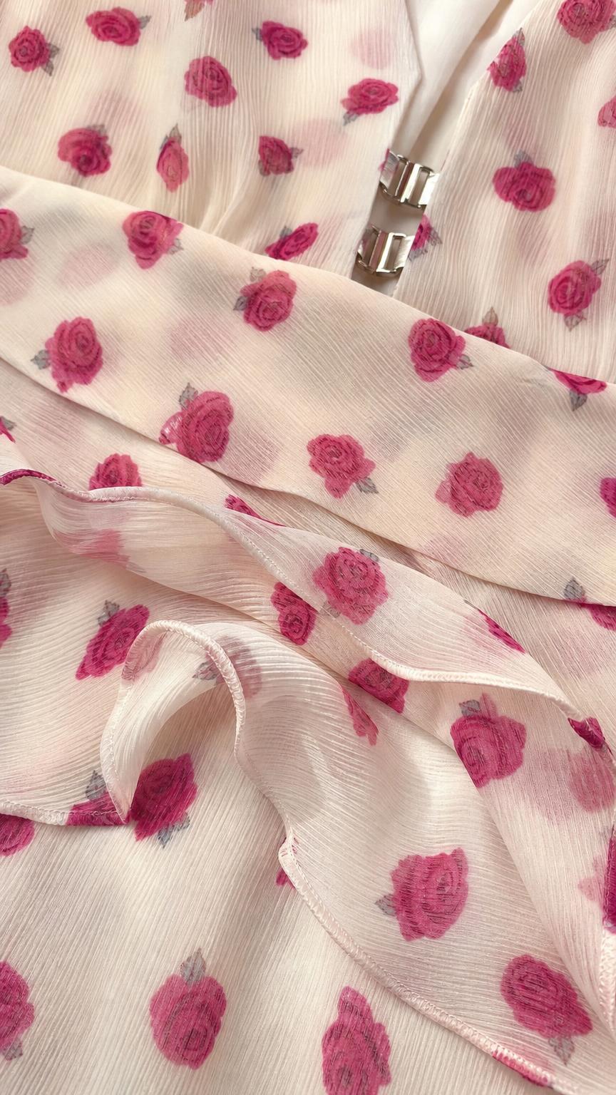 Close-up detail of rose fabric pattern and front clasp hardware