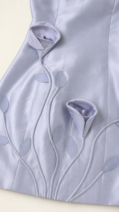 Close-up detail of 3D floral appliques and embroidery on Light Blue dress