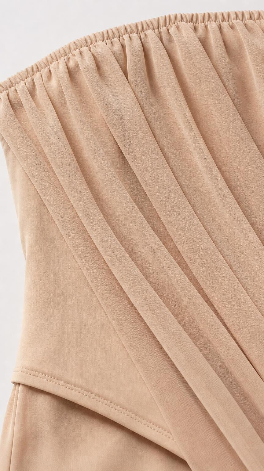 Close-up of gathered strapless neckline and draped fabric detail