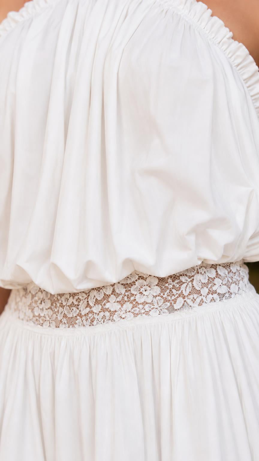 Close-up of gathered bodice and lace waistband on white romper