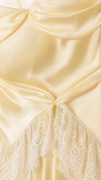 Close-up detail of satin fabric, draped bodice, and lace trim