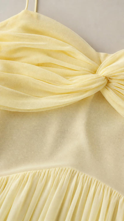 Close-up detail of bodice ruching and pleating on chiffon dress