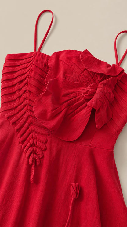 Close-up of red bodice with pleated details and botanical ruffles