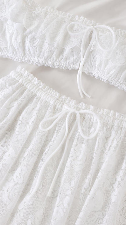 Close-up detail of white lace crop top and skirt drawstring