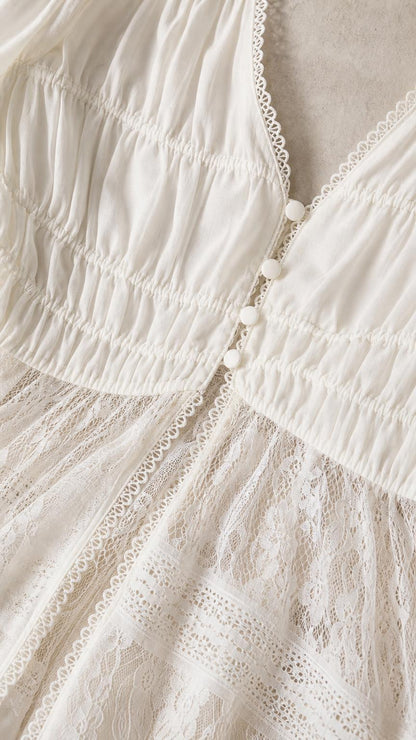 Close up of bodice, buttons, and lace detail on white top
