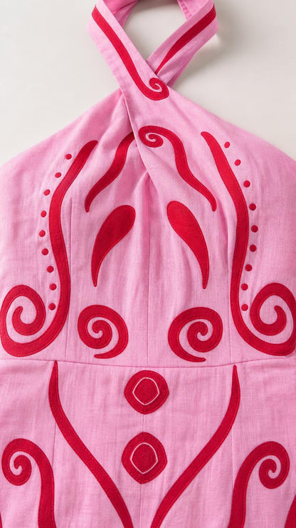 Close-up of the twist-front halter neckline and abstract print