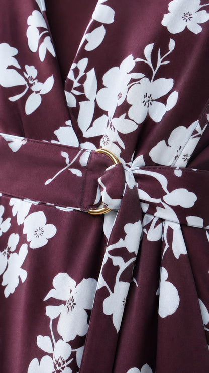 Close-up of burgundy floral fabric and gold-tone ring waist detail