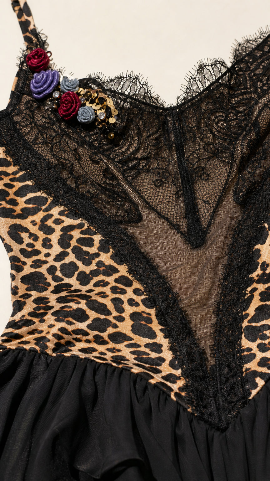 Close-up detail of lace neckline and floral embellishment