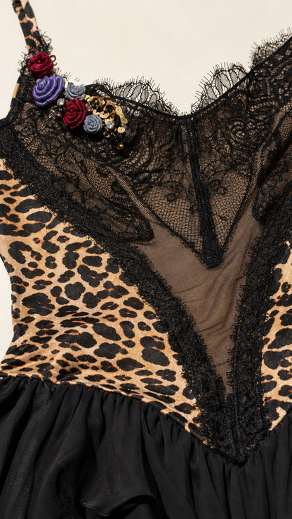 Close-up detail of lace neckline and floral embellishment