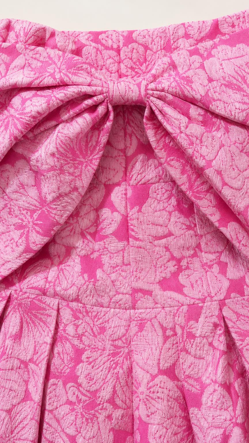 Close-up of the textured floral jacquard fabric and bow detail