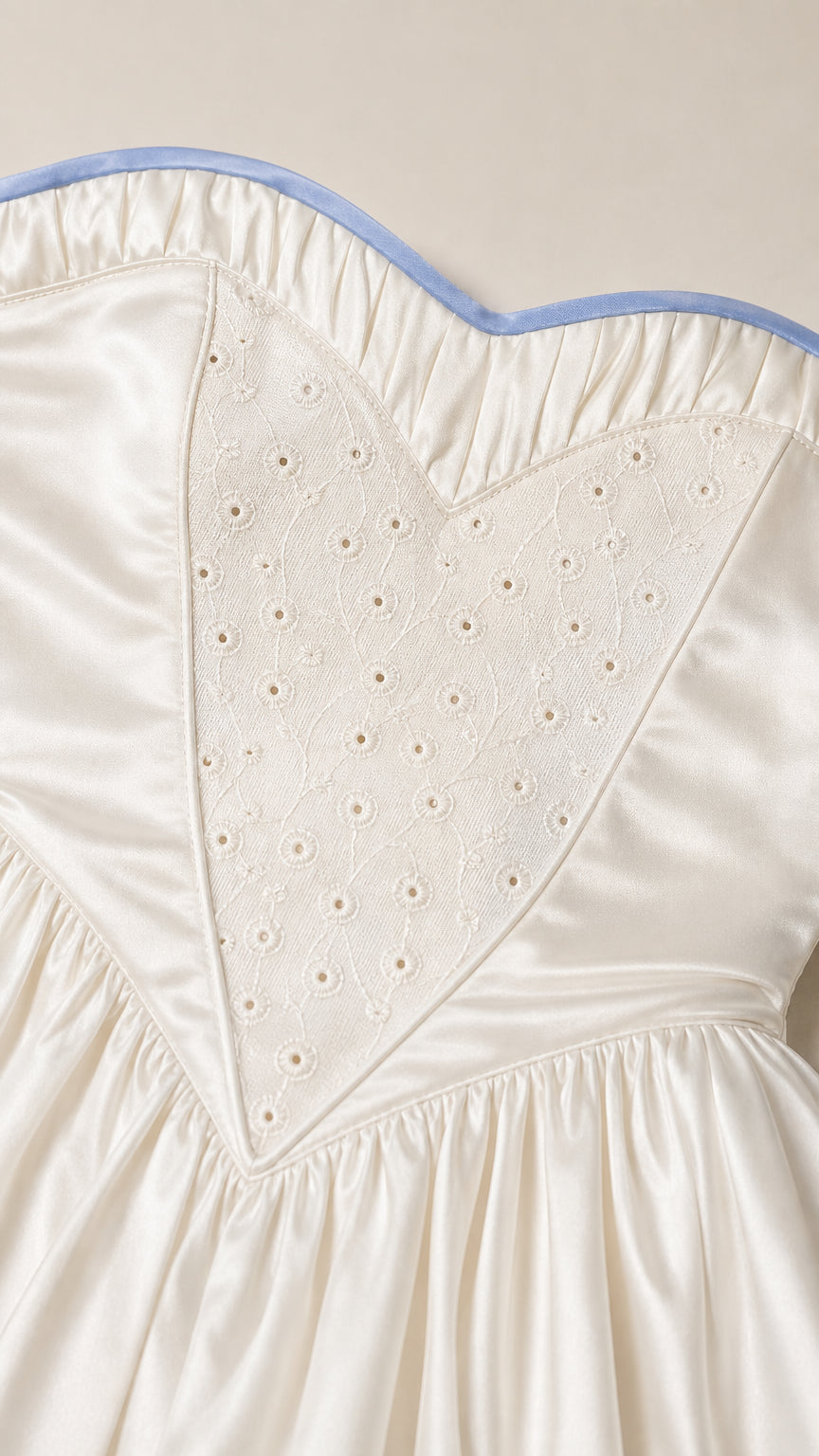 Close-up of heart-embroidered bodice and contrast piping