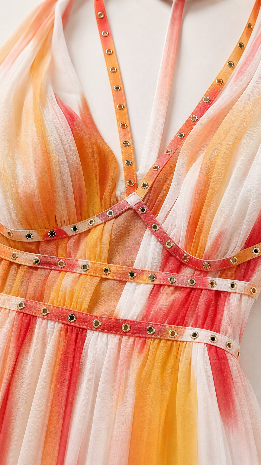 Close-up detail of metallic grommets on dress straps and waist