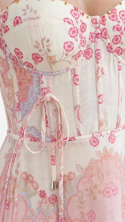 Close-up of structured corset bodice with floral pattern and tie details