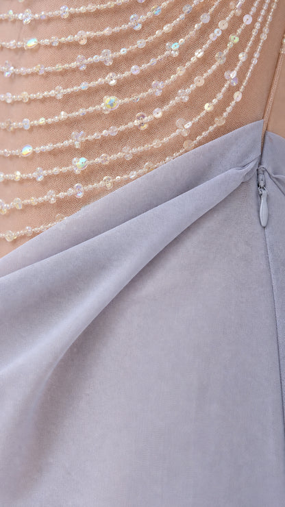 Close-up detail of crystal beading on sheer bodice and side zipper construction