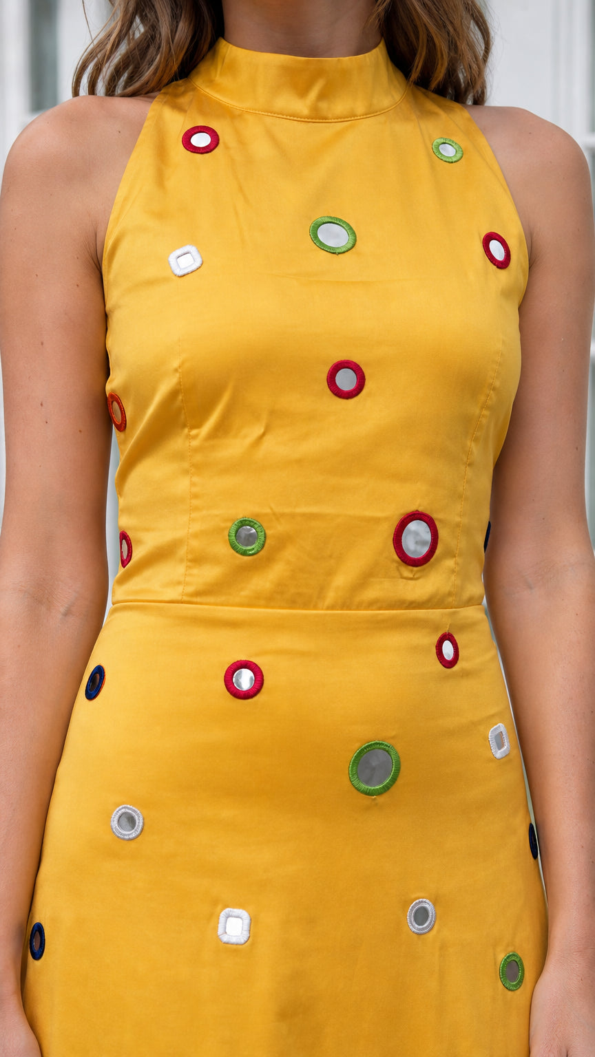 Close-up of bodice details on yellow high-neck embellished maxi dress