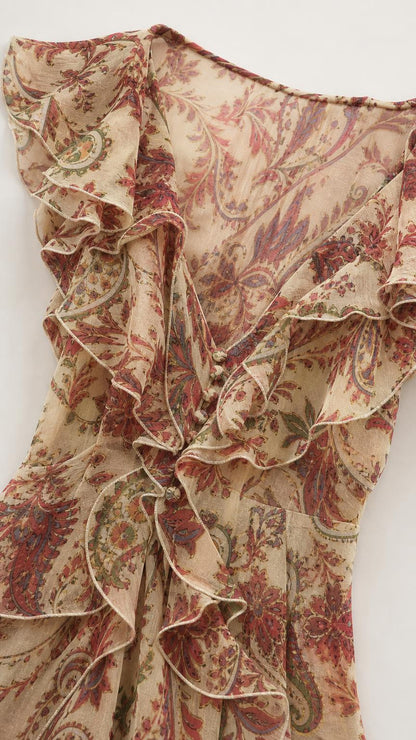 Close-up detail of V-neckline with ruffles and buttons