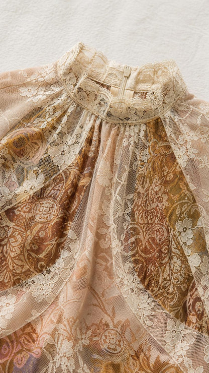 Close-up detail of the high lace neckline and delicate patterned fabric