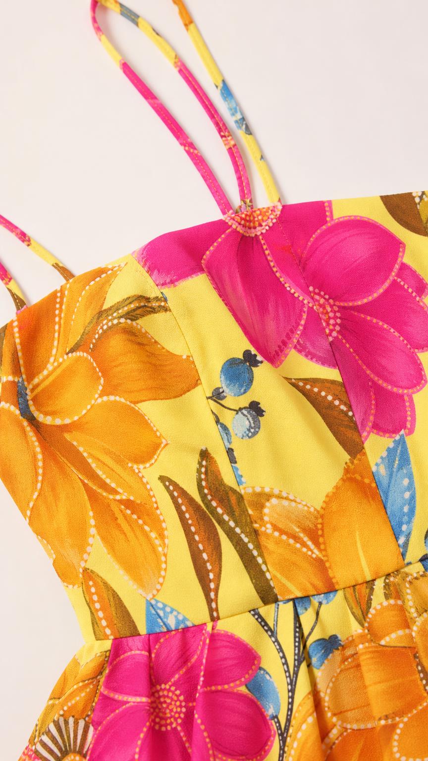 Close-up detail of the bodice, straps, and floral print fabric