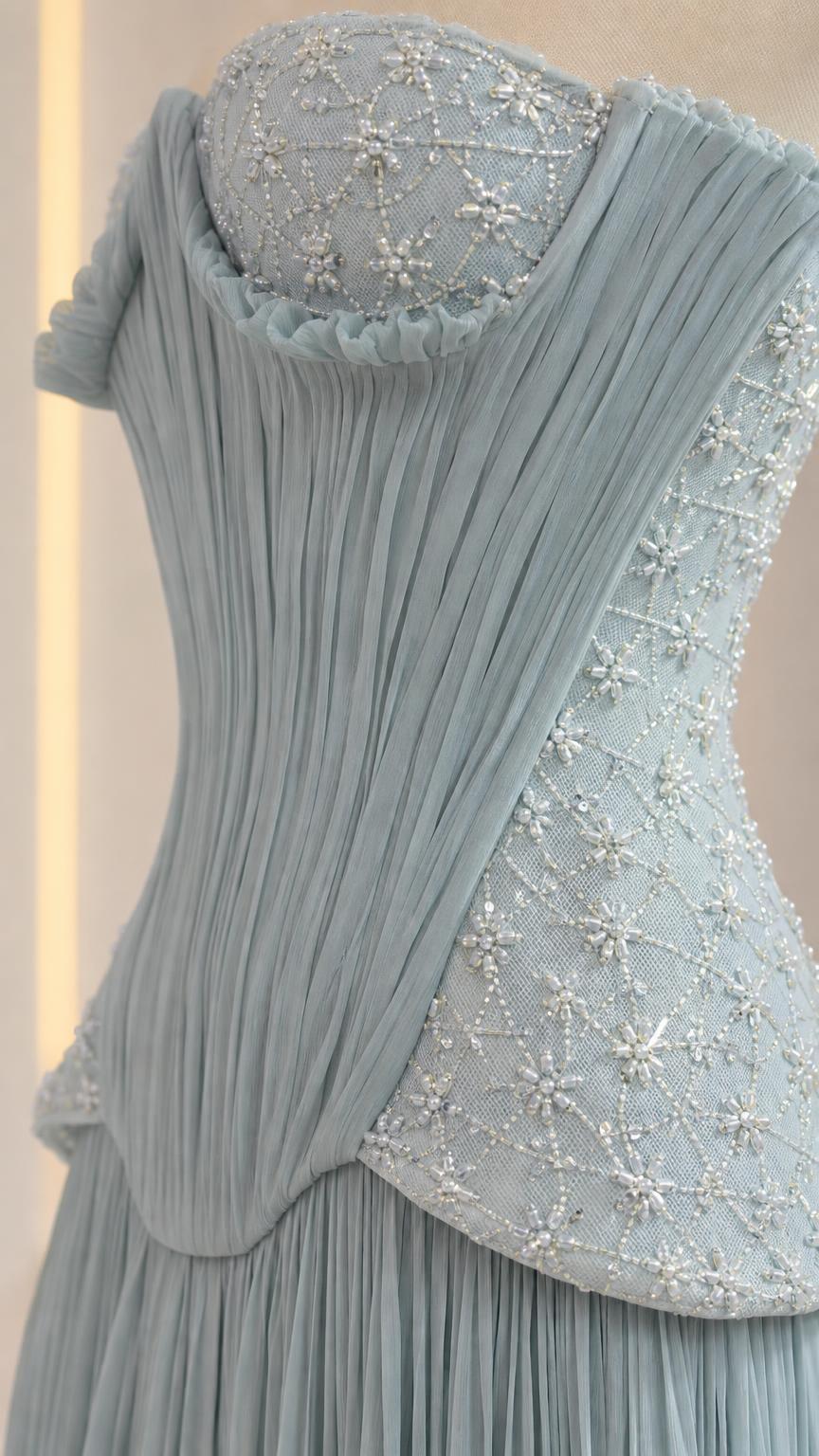 Close-up detail of beaded and sequined corset bodice with draped peplum