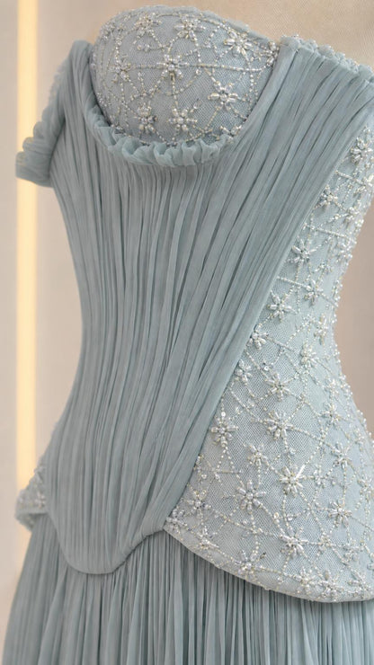Close-up detail of beaded and sequined corset bodice with draped peplum