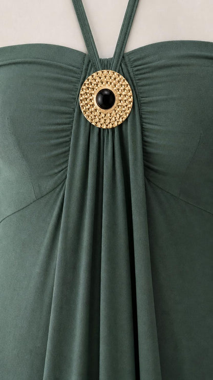 Close-up of metallic ring accent on green dress neckline