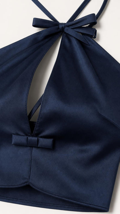 Close-up detail of navy halter necktie and front bow accent