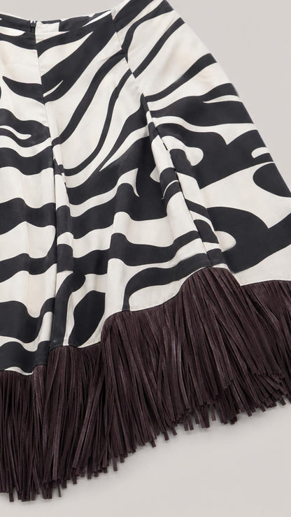 Close-up detail of the fringe hem on the zebra print maxi skirt