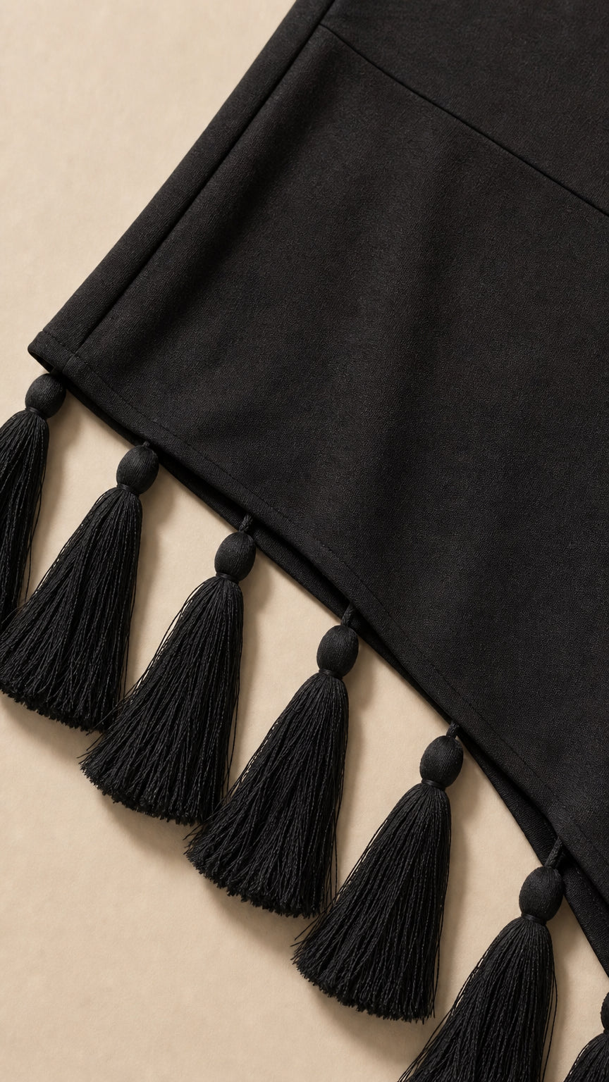Close-up of asymmetrical tassel hem detail