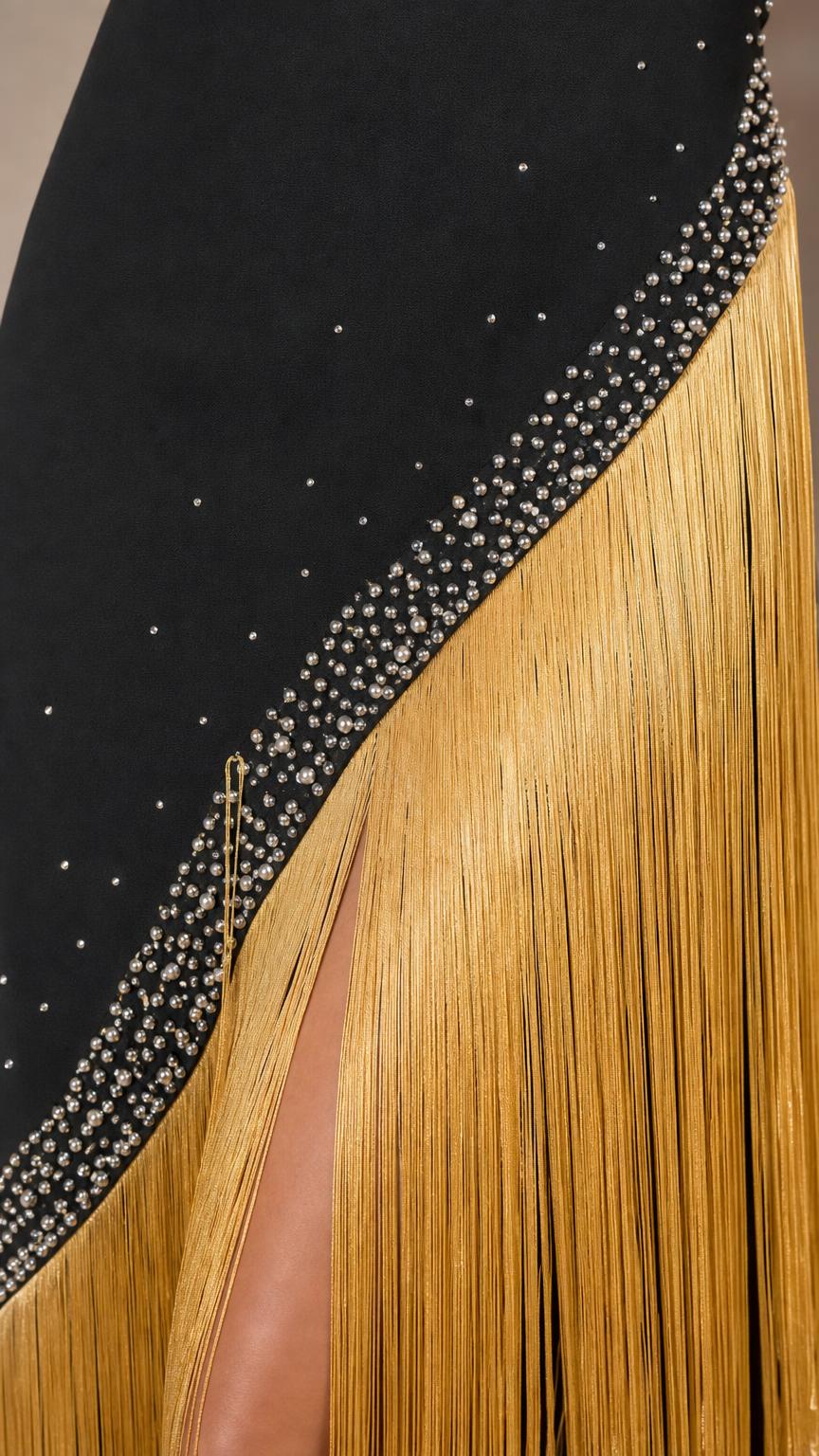 Close up of rhinestone and gold fringe detail on dress