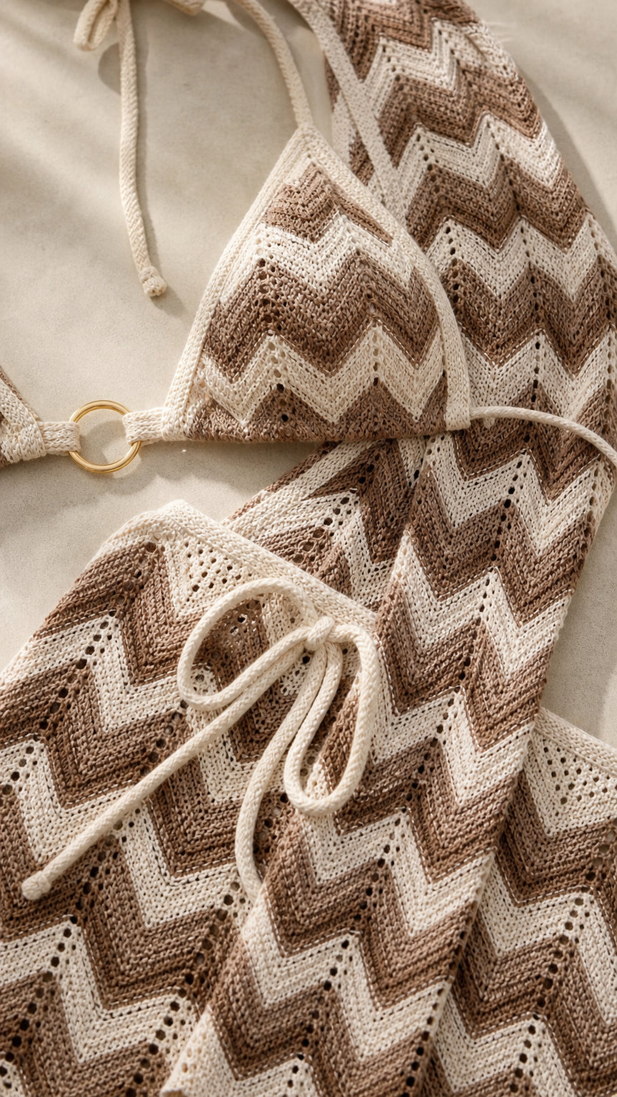 Close-up detail of beige chevron pattern and hardware