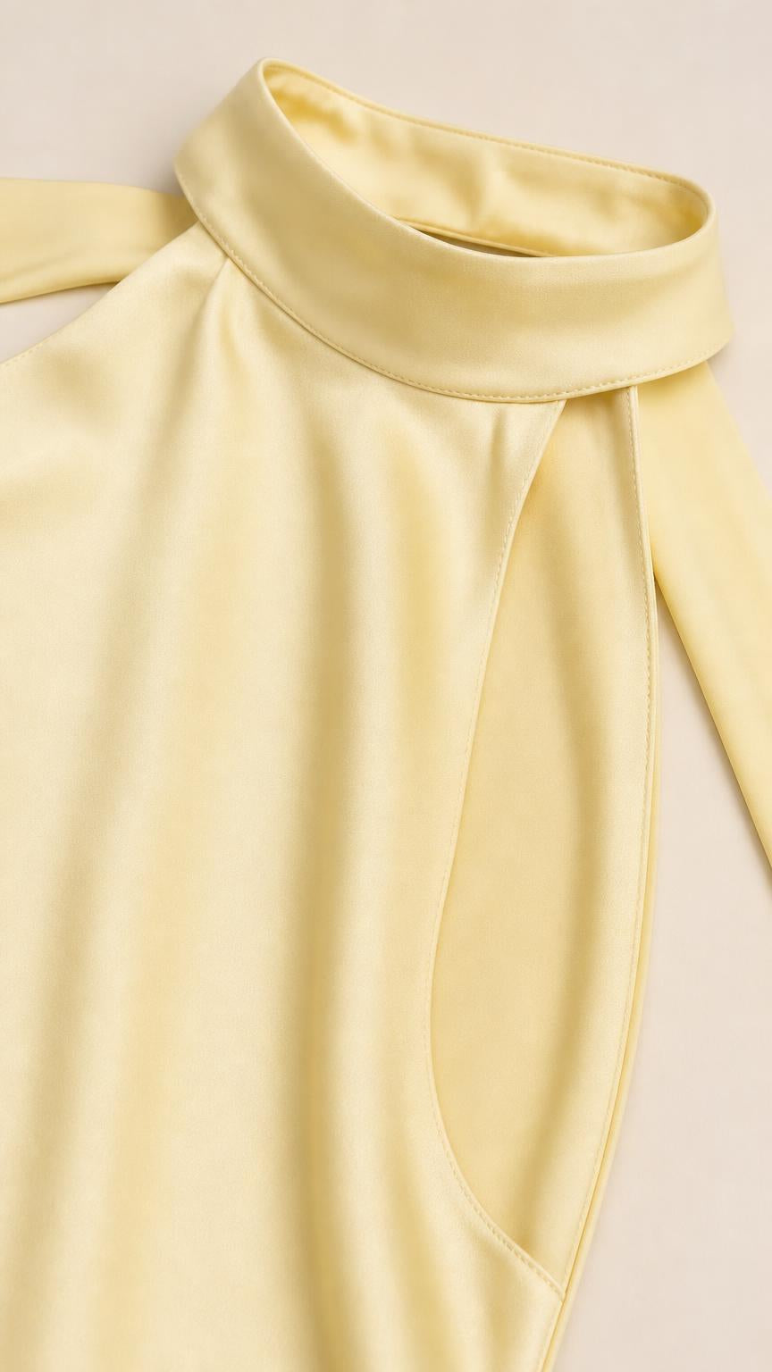 Close-up detail of the high halter neckline and fabric of the yellow dress