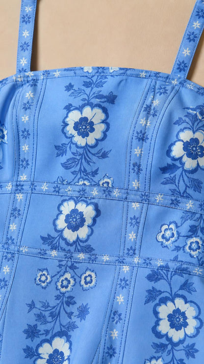 Close-up of blue floral print and square neckline details
